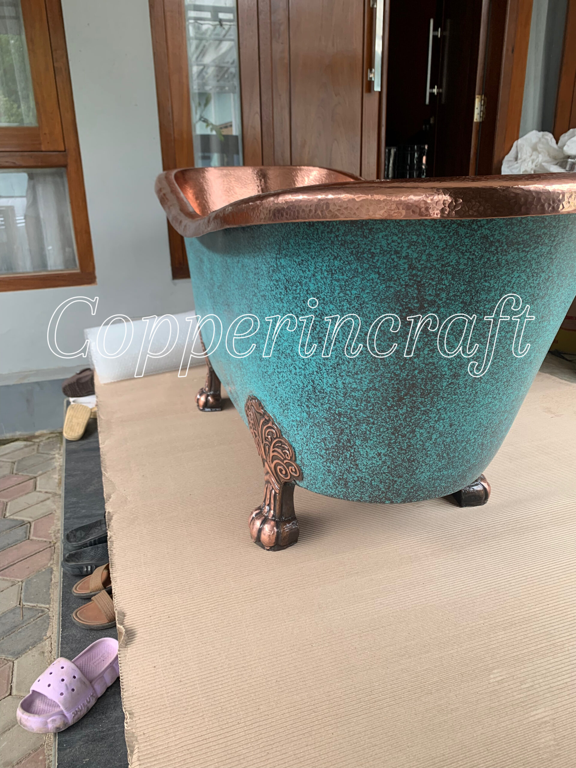 Vintage copper soaking tub with ornate claw feet, handcrafted pure copper bathtub for luxury bathroom design.